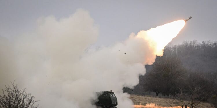 NATO soldiers operate a High Mobility Artillery Rocket System launcher during the Dynamic Front 26 exercise at the Cincu Training Area in Cincu, Romania, on Feb. 9, 2026.
