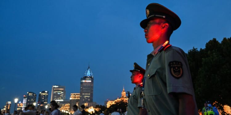Chinese paramilitary police stand guard on the Bund in Shanghai on July 17, 2026.