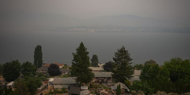 Canada puts the military on standby as British Columbia wildfires kill 1 and displace thousands