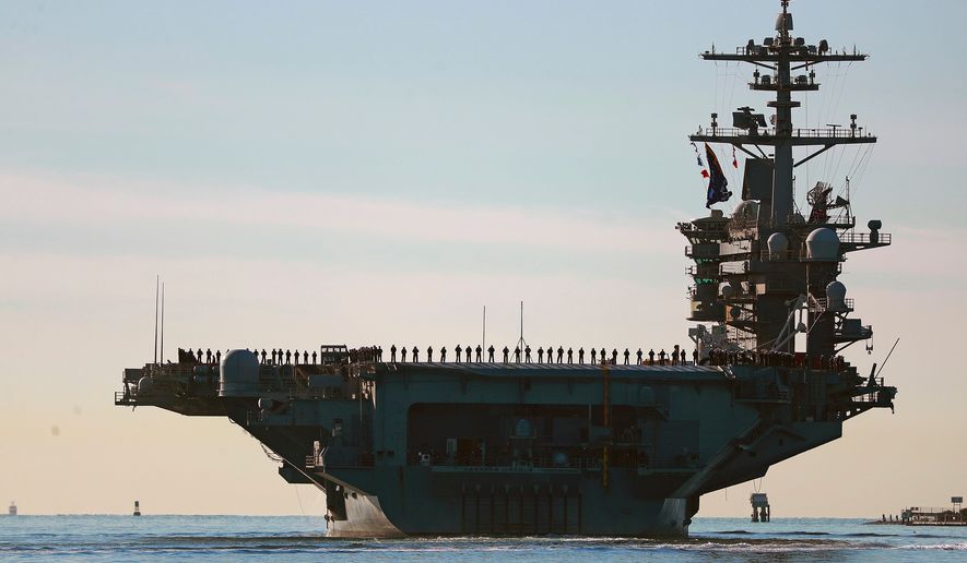Sailors and Marines line the deck of aircraft carrier USS Abraham Lincoln (CVN-72) as it deploys from San Diego on Jan. 3, 2021. (K.C. Alfred/The San Diego Union-Tribune via AP) **FILE**