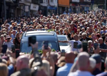 Bonnie Tyler fans line the streets of a Welsh village as her coffin is brought home