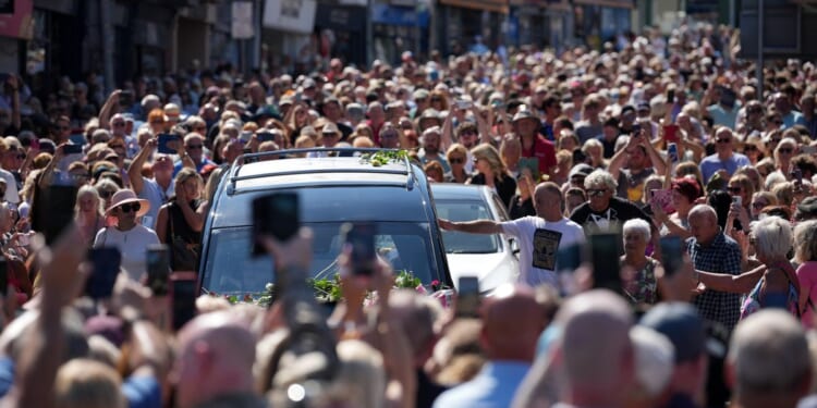 Bonnie Tyler fans line the streets of a Welsh village as her coffin is brought home