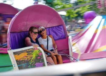 Spinning and dipping, Minnesota fairgoers delight in the classic Tilt-A-Whirl ride as it turns 100