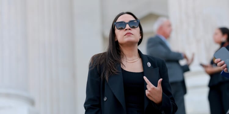 Rep. Alexandria Ocasio-Cortez speaks to reporters on the House steps after a series of votes at the U.S. Capitol on July 22, 2026, in Washington, D.C.