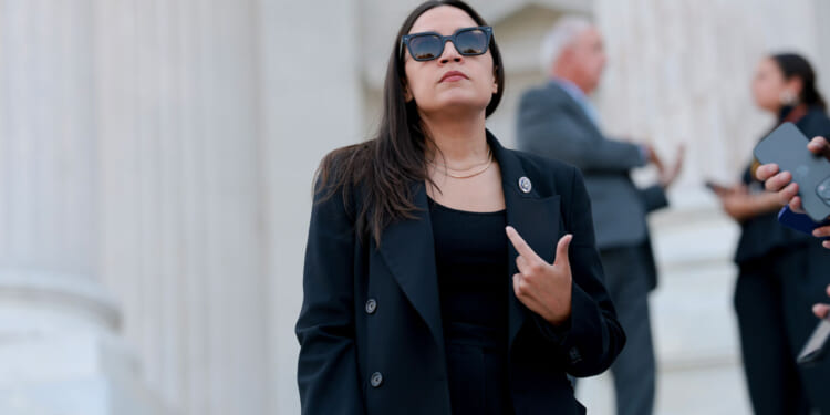 Rep. Alexandria Ocasio-Cortez (D-NY) speaks to reporters on the House steps after a series of votes at the U.S. Capitol on July 22, 2026 in Washington, DC. The House of Representatives passed legislation funding for the 2027 NDAA defense programs and banned insider stock trading among lawmakers. (Photo by Anna Moneymaker/Getty Images)