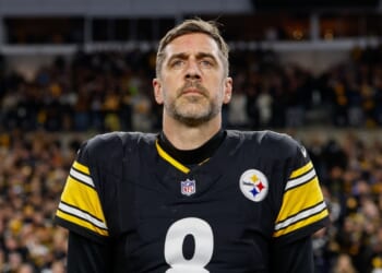 Aaron Rodgers of the Pittsburgh Steelers stands for the national anthem prior to the AFC Wild Card playoff game against the Houston Texans at Acrisure Stadium on Jan. 12, 2026, in Pittsburgh, Pennsylvania.