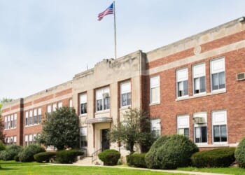 The exterior view of a typical American school building seen on a spring day.