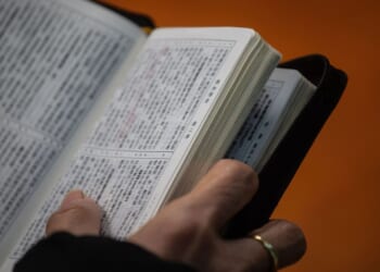 A Christian worshipper holds a Bible while attending a church service in Hong Kong on Dec. 23, 2018.