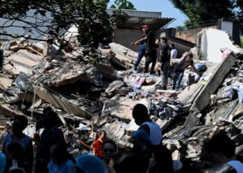 Locals work to clear out a collapsed building after an earthquake hits Cali, Colombia on Aug. 10, 2026.