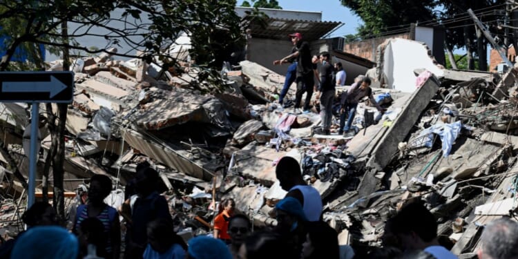 Locals work to clear out a collapsed building after an earthquake hits Cali, Colombia on Aug. 10, 2026.