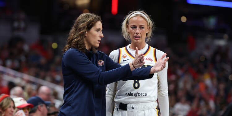 Sophie Cunningham of the Indiana Fever talks with head coach Stephanie White during the game against the Phoenix Mercury at Gainbridge Fieldhouse on June 24, 2026, in Indianapolis, Indiana.