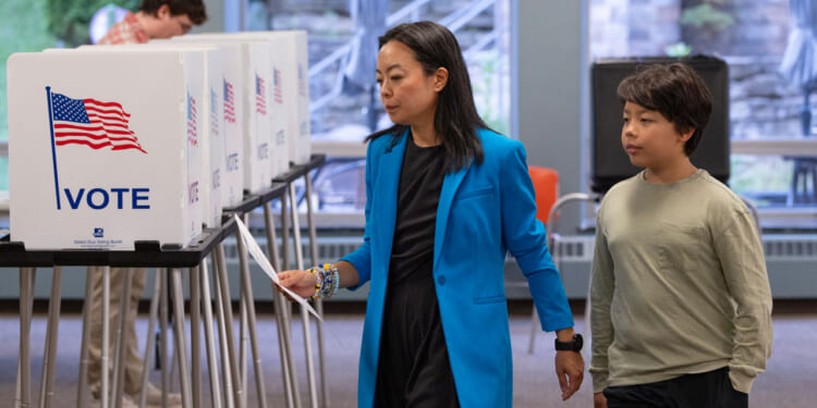 With her son George by her side, Democratic Wisconsin Gubernatorial candidate Francesca Hong votes in the primary election.