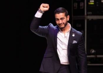 Abdul El-Sayed pumps his fist in the air at a campaign rally on August 4, 2026.