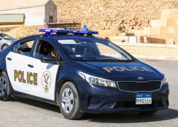 An Egyptian police car sits on a road.