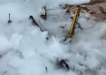 Clouds of gas spewed out of a work site after an unoccupied semi truck reportedly rolled into the pipeline, damaging it.