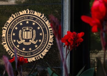 The FBI signage is displayed among a bed of flowers in Washington, D.C. on August 8, 2026.