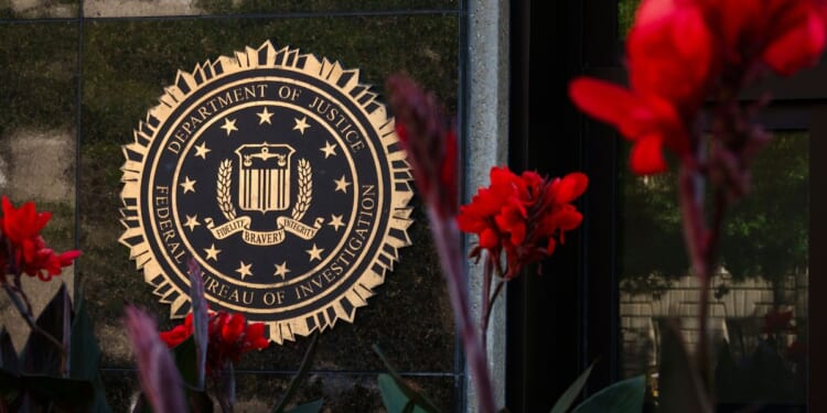 The FBI signage is displayed among a bed of flowers in Washington, D.C. on August 8, 2026.