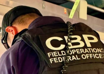 A U.S. Customs and Border Patrol agent vets passengers at the border between Canada and the U.S.