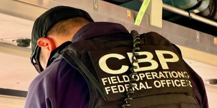 A U.S. Customs and Border Patrol agent vets passengers at the border between Canada and the U.S.