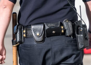 A close-up shot of a police officer from behind.