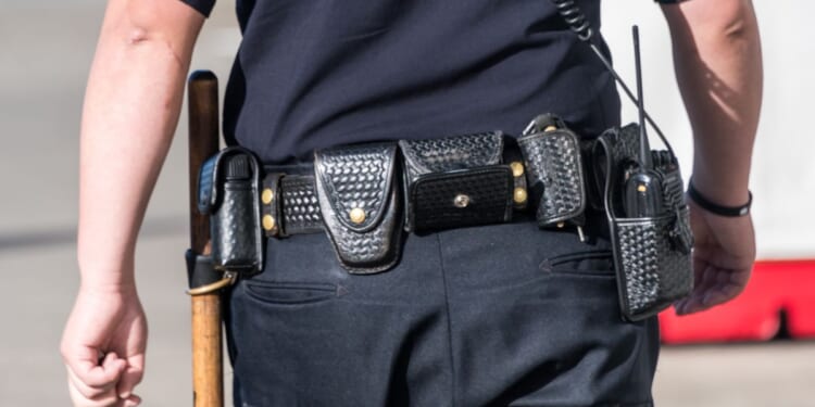 A close-up shot of a police officer from behind.