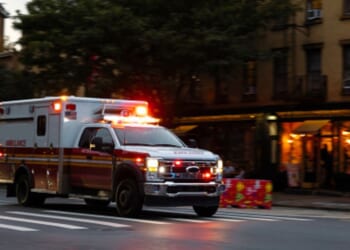 An ambulance zooms down a Manhattan street in New York City.