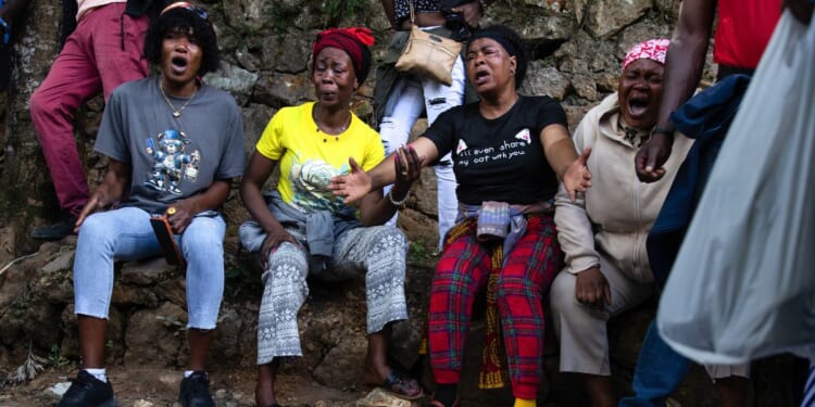 Haitians react in grief following overnight violence where more than 40 people were killed by armed gangs in Kenscoff, a neighborhood near Port-au-Prince, Haiti.