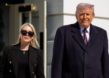 President Donald Trump, accompanied by White House Press Secretary Karoline Leavitt, walks toward the media as he departs on Marine One on the South Lawn of the White House on Feb. 27, 2026, in Washington, D.C.