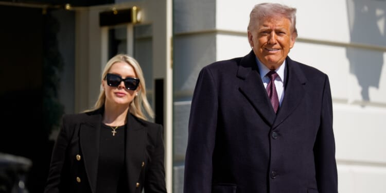 President Donald Trump, accompanied by White House Press Secretary Karoline Leavitt, walks toward the media as he departs on Marine One on the South Lawn of the White House on Feb. 27, 2026, in Washington, D.C.