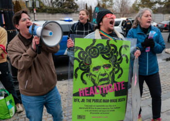 Protesters with Gender Liberation Movement and ACT UP demonstrate outside the Department of Health and Human Services while protesting the Trump administration’s plan to cut federal funding to clinics providing care for transgender youth on February 17, 2026 in Washington, DC.