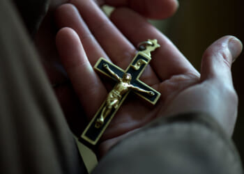 Sister Michaela holding the crucifix on her rosary at the Klarissenkloster convent of St. Clara in Bautzen, Germany, 22 January 2016. Katrin Damm grew up in a non-religious home but chose to be baptised in 2006, after finding God. She finally entered the order of the Klarissen (Poor Clares) as Sister Michaela in 2009. The Poor Clares follow the way of life of Clare of Assisi, a contemporary and follower of St. Francis of Assisi. PHOTO: ARNO BURGI