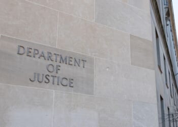 A Department of Justice sign on the side of the agency's headquarters in Washington.