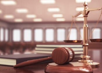 A judge's gavel in an empty courtroom.