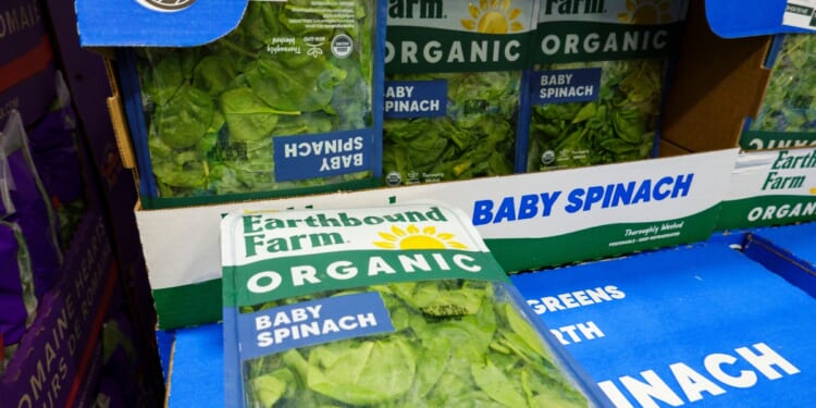 Packages of Earthbound Farm organic baby spinach are displayed for sale in the refrigerated produce department at a Costco Wholesale warehouse on July 29, 2026, in Arlington, Virginia.