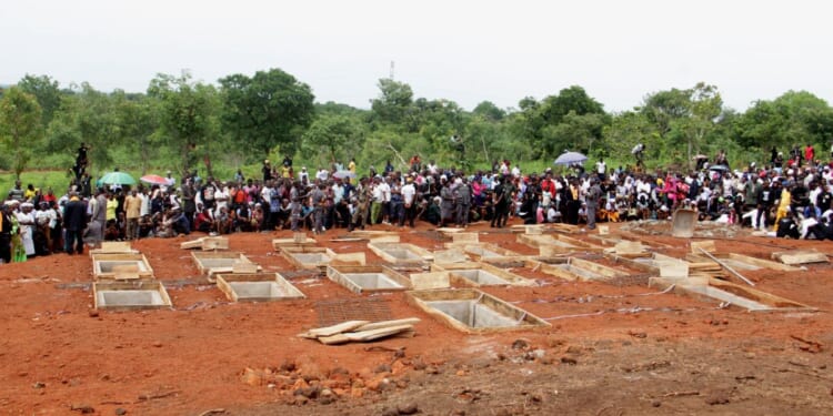 The graves of 17 Christian worshippers and two priests who were murdered by Fulani herdsmen sit open in north-central Nigeria on May 22, 2018.