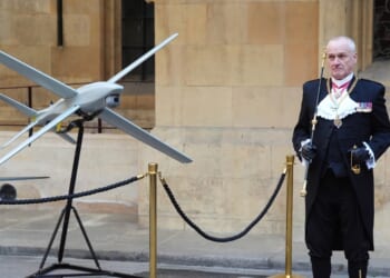 Gentleman Usher of the Black Rod, Lieutenant General Ed Davis, stands by a drone in Speaker's Square in central London on March 17, 2026, during a visit to the Palace of Westminster, home to Britain's Houses of Parliament, by Ukraine's President.