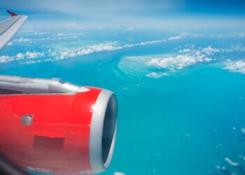 A passenger jet flies over the Caribbean Ocean near Haiti. The U.S. deported 162 individuals back to Haiti Aug. 20, many of whom have lengthy rap sheets.