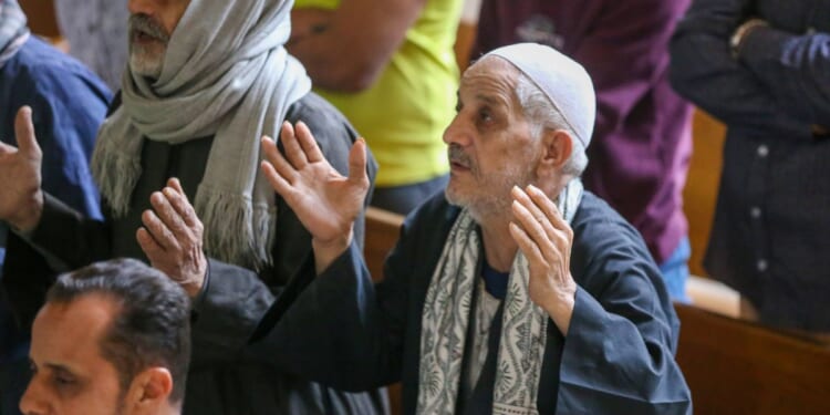 Coptic Christians in worship at a Palm Sunday service in Cairo, Egypt on April 5, 2026.