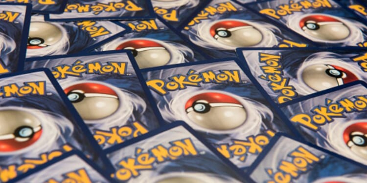 Pokémon Cards lay on a table.