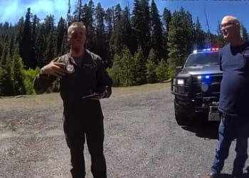 A Marine Corps pilot talks to deputies shortly after crashing his fighter jet in June in Washington state.