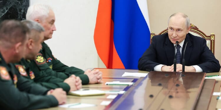 Russian President Vladimir Putin meets with Russian Defense Ministry leadership Wednesday in a photo distributed by the Russian state agency Sputnik.