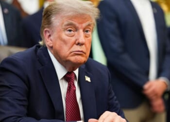 President Donald Trump sits at the Resolute Desk in the Oval Office on July 24, 2026.