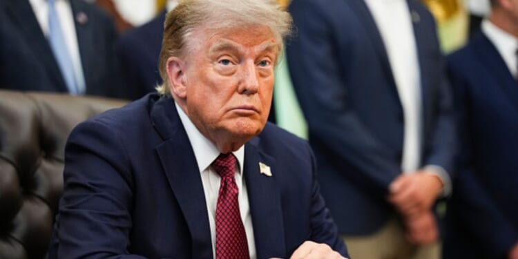 President Donald Trump sits at the Resolute Desk in the Oval Office on July 24, 2026.