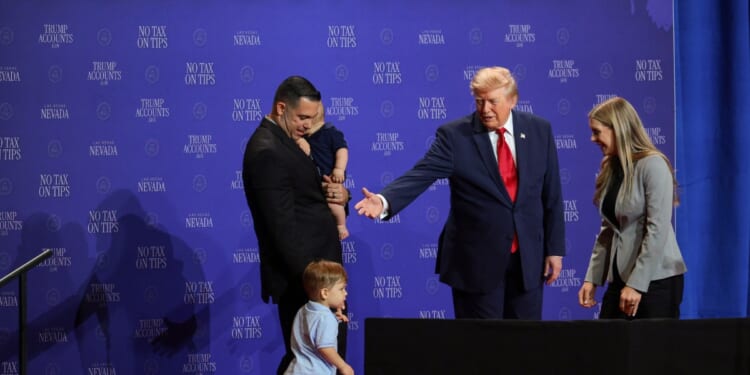 President Donald Trump introduces a family who has benefitted from the "no tax on tips" policy onstage during an event at Red Rock Casino Resort and Spa on Aug. 5, 2026, in Las Vegas, Nevada.