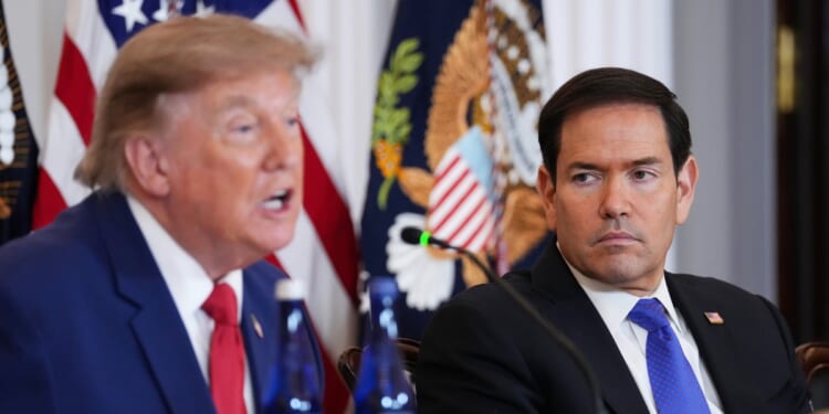 Secretary of State Marco Rubio listens as President Donald Trump speaks during a roundtable on the American mining industry at the Department of State on Aug. 7, 2026, in Washington, D.C.