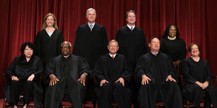 The justices of the United States Supreme Court pose for a photograph in Washington on Oct. 7, 2022.