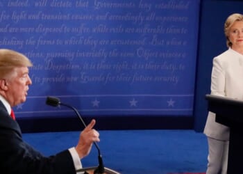 Democratic nominee Hillary Clinton looks on as Republican nominee Donald Trump speaks during the final presidential debate at the Thomas & Mack Center on the campus of the University of Las Vegas in Las Vegas, Nevada, on Oct. 19, 2016.