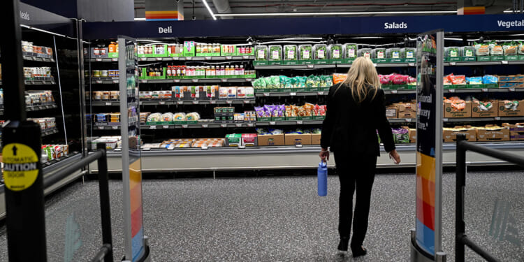 A woman walks near food on display in an Aldi grocery store in New York City, June 17, 2026. REUTERS/Vincent Alban/File Photo