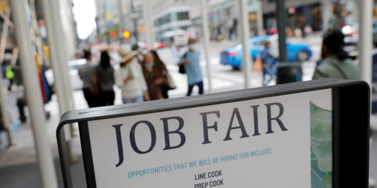 Signage for a job fair is seen on 5th Avenue after the release of the jobs report in Manhattan, New York City, Sept. 3, 2021. REUTERS/Andrew Kelly