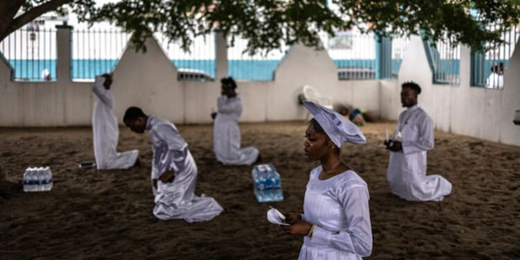 Christians kneel in worship on July 12, 2026 in the Ketu neighborhood of Lagos.